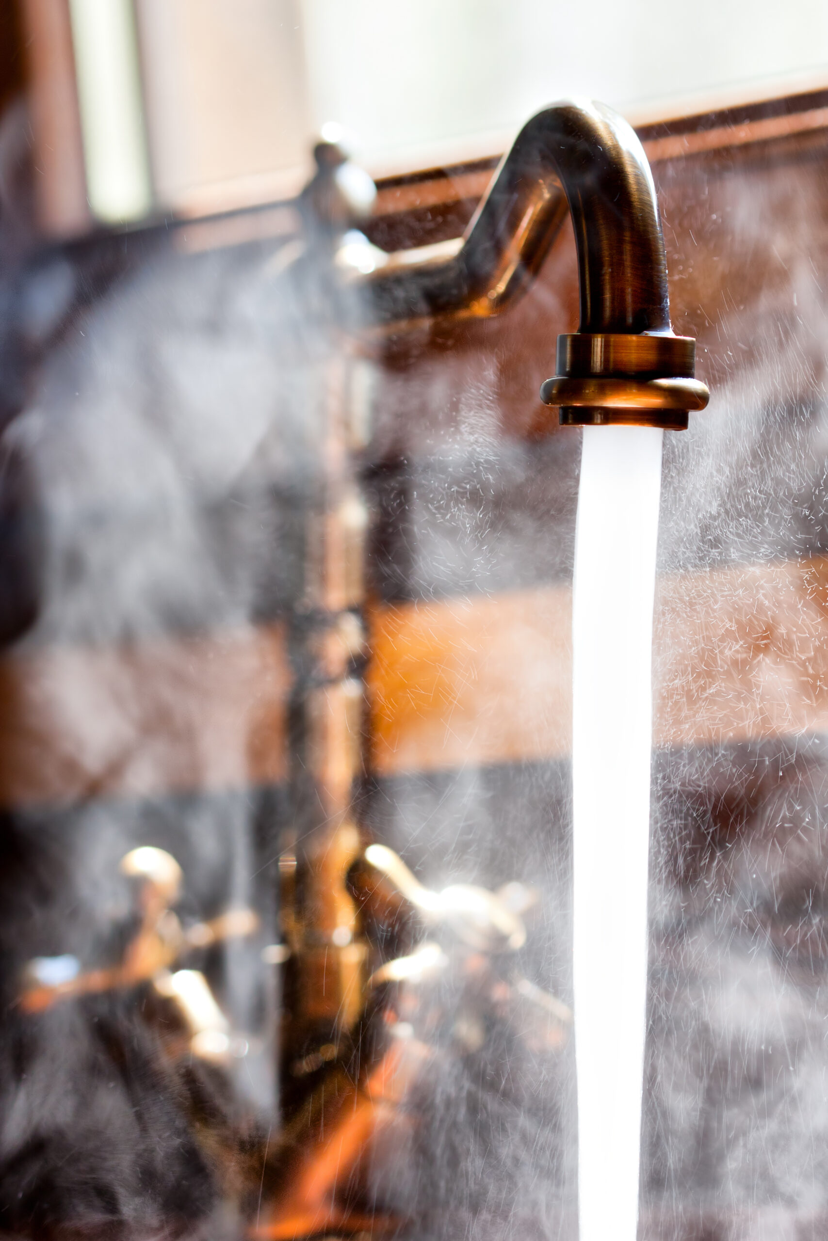Running vintage faucet with hot water. Close-up view