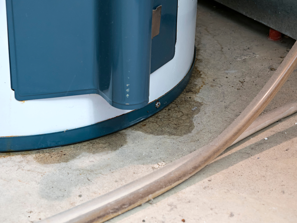 a puddle of water beneath the base of a water heater