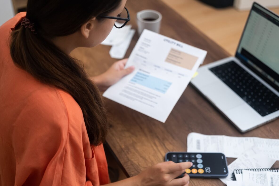 female homeowner calculating and paying water bills