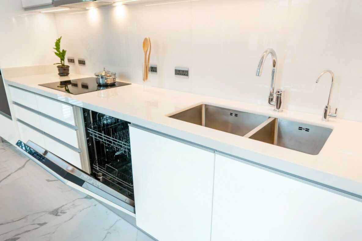 dishwasher and kitchen sink installed right next to each other in a white kitchen