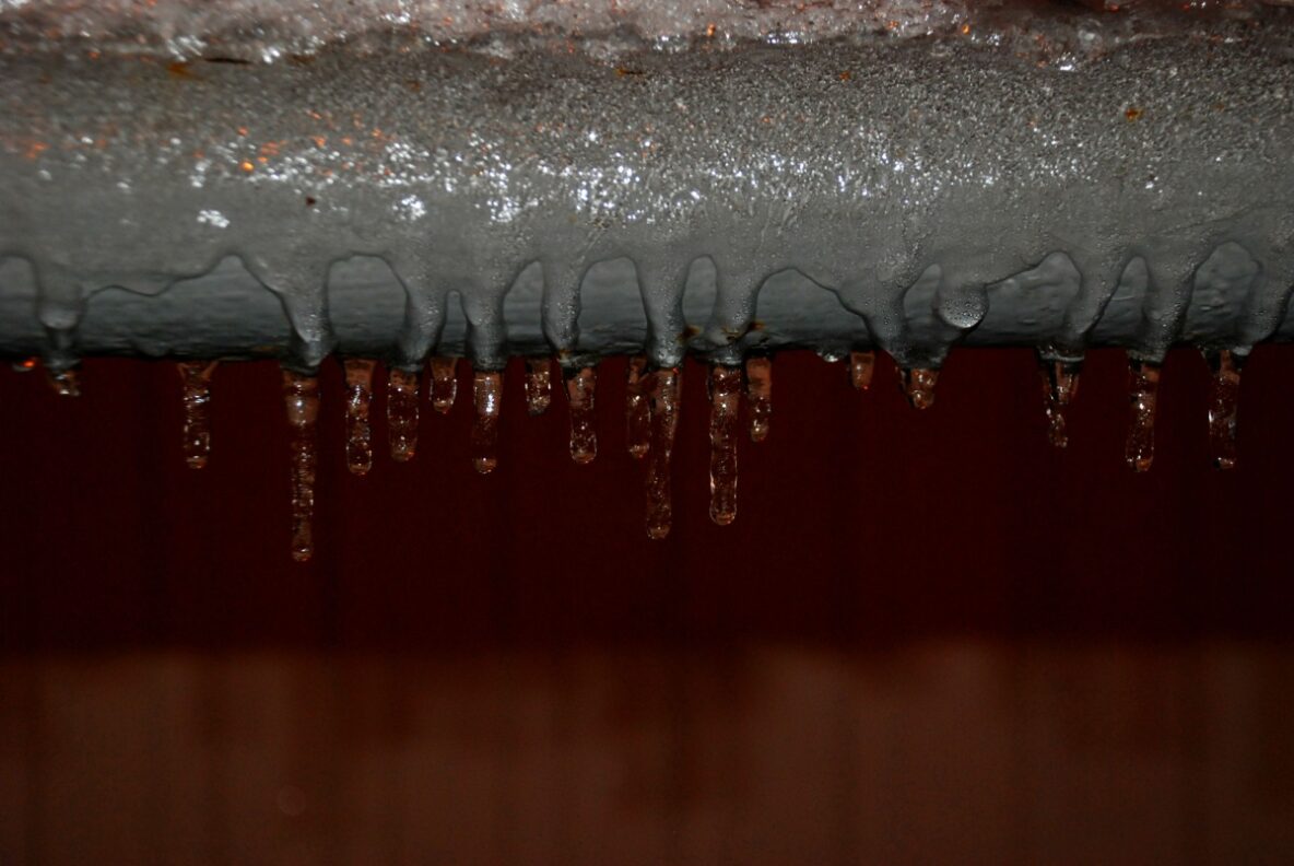 A frozen pipe with ice crystals